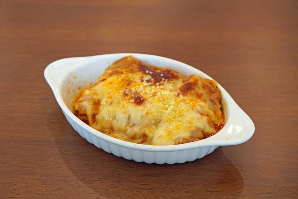 stock image Lasagna, an Italian dish made of stacked layers of lasagna alternating with fillings such as ground meats and tomato sauce, vegetables, cheeses and seasonings and spices. Selective focus