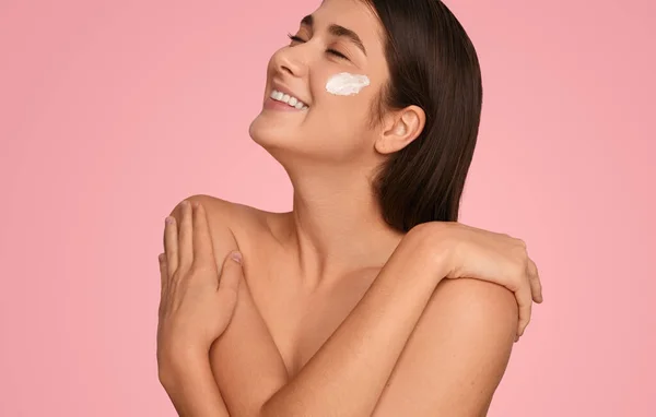 Happy Young Woman Cream Cheek Smiling Closed Eyes Touching Bare — Stockfoto