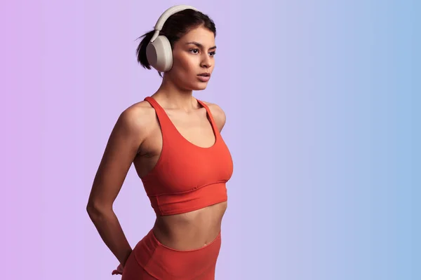 Slim Ethnic Female Sportswear Listening Music Wireless Headphones While Standing — Stock Photo, Image