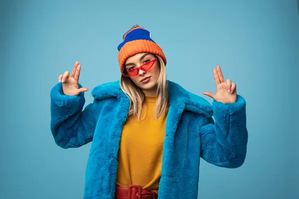 Stylish Young Female Fur Jacket Cap Gesturing Signs While Looking — Stock Photo, Image