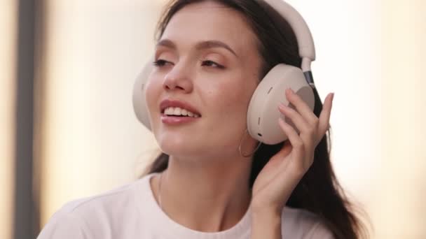 Zbliżenie Pięknej Nastolatki Noszącej Słuchawki Tłumiące Hałas Słuchającej Muzyki Uśmiechającej — Wideo stockowe
