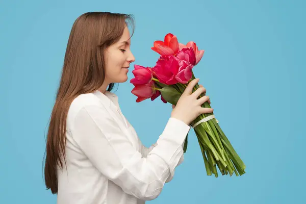 Side View Cheerful Brunette White Shirt Smelling Beautiful Tulips Blue Stock Image