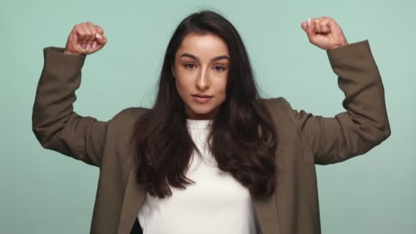 Empowered Young Armenian Woman Poses Playfully Flexing Her Muscles While — Stock Video