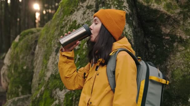Woman Yellow Jacket Beanie Pauses Coffee Break While Hiking Moss — Stock Video