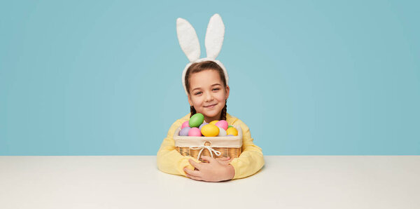 Charming Little Girl Wearing White Bunny Ears Embracing Wicker Basket Royalty Free Stock Images
