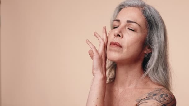 Graceful Senior Woman Gray Hair Tattoo Closes Eyes Embracing Her — Stock Video