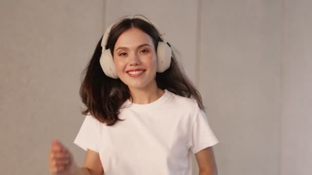 Щаслива Дівчина Підліток Танцює Білій Футболці Насолоджуючись Музикою Через Навушники — стокове відео