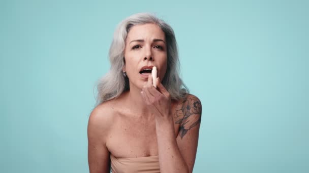 Close Uma Mulher Meia Idade Cuidando Seus Lábios Com Bálsamo — Vídeo de Stock
