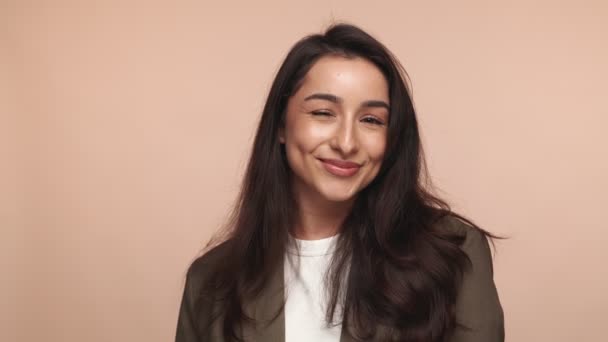 Portrait Joyful Woman Playful Wink Warm Genuine Smile Soft Beige — Stock Video
