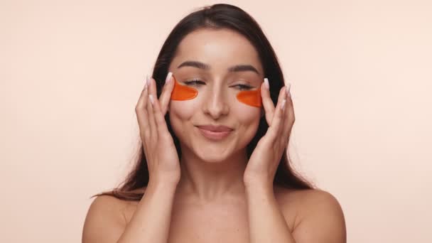 Woman Smiling While Applying Eye Gel Pads Moisturize Rejuvenate Her — стокове відео