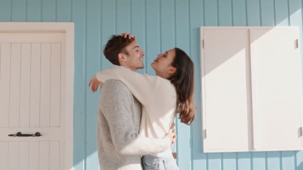 Joyful Affectionate Couple Shares Warm Embrace Smiles Pastel Blue Colored — Stockvideo