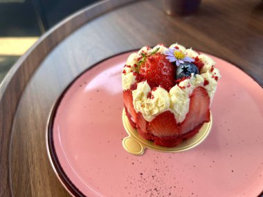 Eski moda Kırmızı Kadife Kek Kafeteryada tatlı tatlı çilek yemeği.