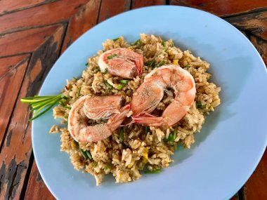 Tayland sokak usulü kızarmış pilav ve büyük taze karides lezzetli, aromatik ve tatmin edici bir yemek sunuyor, karides, kokulu pirinç ve canlı baharatları özgün bir sokak yemeği deneyimi için birleştiriyor..