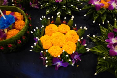 Krathong , People making and decorating Krathong or lotus shaped vessel made of banana leaves contained a candle, three joss sticks and some flowers for Thailand Loy Krathong Festival. clipart