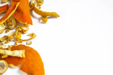 In one side of the photo together lie dry skins of mandarin, orange and sweetie. Dried citrus skins. Ingredients for tea are dried citrus fruits.