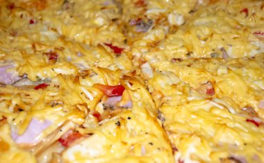 Homemade pizza with an abundance of cheese. Lots of cheese on the pizza. Pica close-up - background photo.