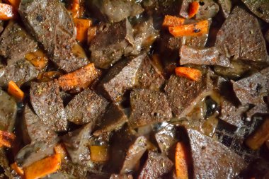 fried liver with carrots. Pork liver with carrots in a frying pan. pickling beef liver.