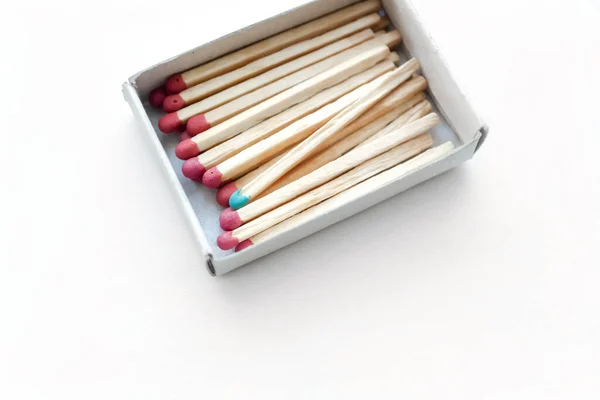 There are many red matches in the matchbox and one blue one. a special match in a box. One match is distinguished by color.