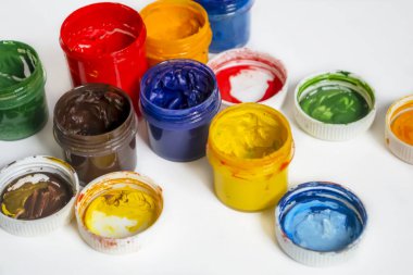 Bonks with watercolor paint. Paints for artists .Watercolor paints of different colors on a white background. Jars with watercolors. oil paints on a white background.