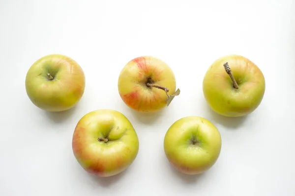 Apples in the form of Olympic symbols. Olympic rings made of apples. beautiful yellow apples on a white background.