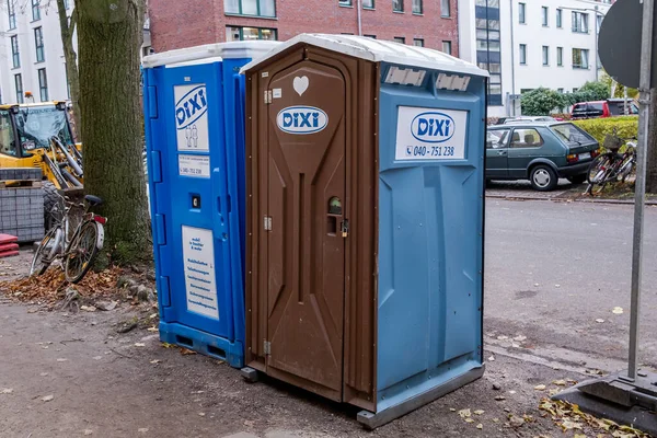 stock image Hamburg, Germany - 12 03 2022: Two DIXI toilet cubicles on a construction site in Hamburg Germany