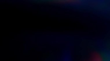 Purple illumination with a rainbow break on a black background. Stock video to overlay light in 4k. Prism breaking effect.