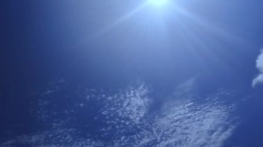 Beyaz bulutlu ve güneş ışınlı mavi gökyüzü videosu. Gökyüzü manzaralı güzel bir stok klipsi..
