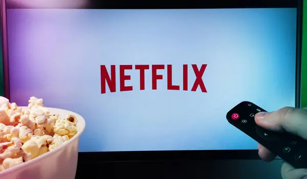 stock image Kyiv. Ukraine. 11.12.2023: Person watching Netflix with popcorn and a remote control. Stock editorial photo.