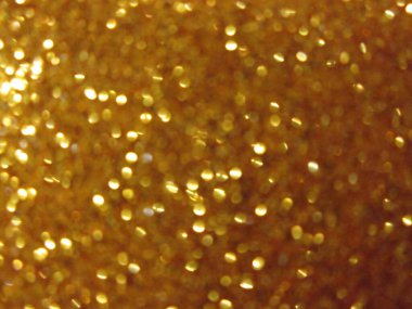 Altın parıltı canlı bir şekilde parıldıyor, ışığı yakalıyor ve canlı, şenlikli bir görünüm yaratıyor. Bu dokulu arkaplan yaratıcı projeler ve kutlamalar için idealdir..