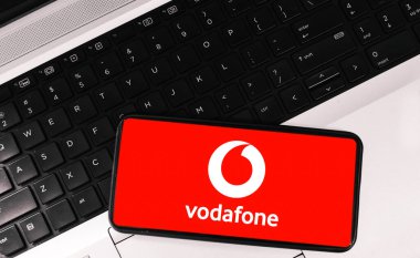 Telecommunication company concept inside mobile screen and laptop in the backdrop, tech editorial background