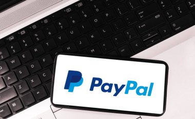 Paypal online payment gateway editorial background with mobile screen and laptop