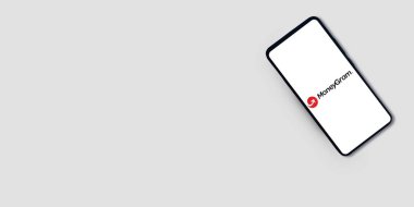 Moneygram on mobile screen with empty space banner editorial background