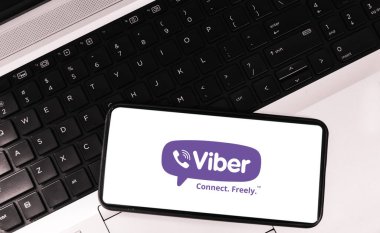 Mobile application for messaging sign on screen with laptop in the background. Viber editorial backdrop