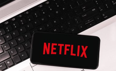 Online streaming platform concept background with mobile screen and monogram. Editorial ott platform netflix on mobile backdrop