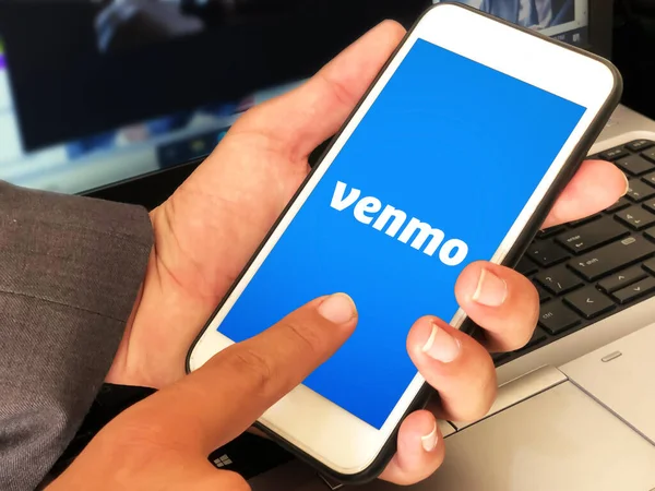 Stock image Mobile online payment service Venmo editorail background. Man touching and using mobile application for payment and financial services