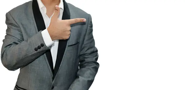 stock image Model Pointing with finger on the right side of his shoulder wearing gray suit on white isolated backdrop