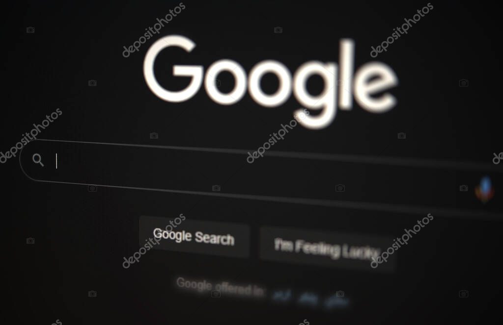 Google Web version in Dark Mode, editorial background. Famous Search engine opened on screen, backdrop