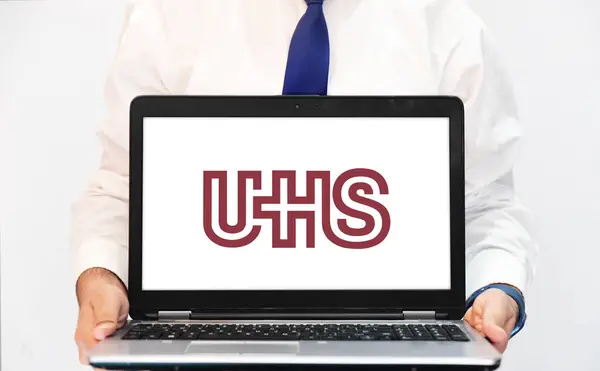stock image Universal Health Services is a hospital company in USA, showing the logo on the laptop screen. Editorial healthcare concept