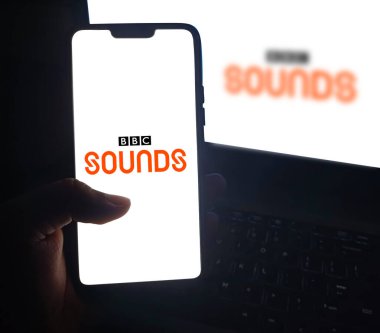 BBC Sounds Application on smartphone screen, editorial backdrop for music app clipart
