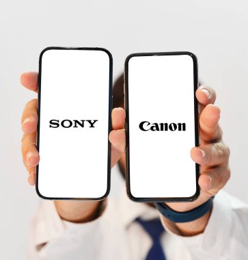 Sony vs canon Conparison konsept editoryal arkaplan elinde iki akıllı telefon