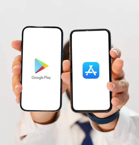 stock image PlayStore vs Apple Editorial Background with Two Smartphones in Hand for App Availability, Features, and User Experience