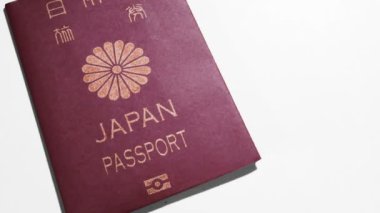 Japonya pasaportu beyaz arka fona yerleştirilmiş, seyahat belgesi 4K görüntü
