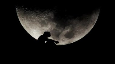 Arka planda ay ışığı olan yalnız bir adam. Umutsuz ve yalnızlık kavramı