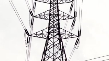 High voltage transmission towers with complex steel structures.