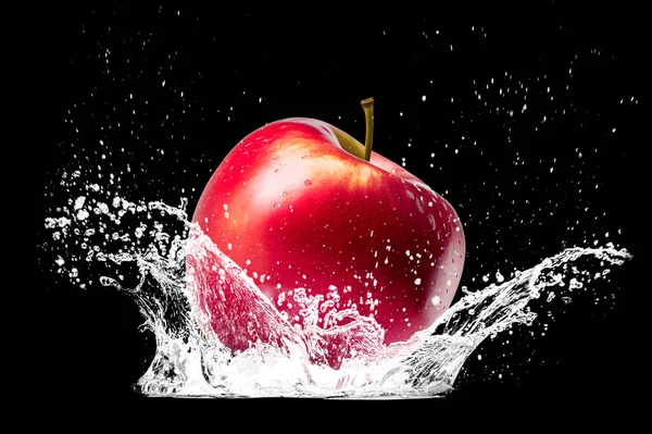 Splashing water and red apple on black background. water splash refreshing