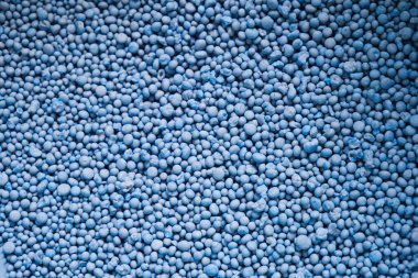 Chemical fertilizer pellets ready for use in agricultural plots, formula NPK 15-15-15 for decorating projects. clipart