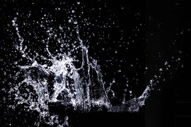 Splashing water on a black background. water splash refreshing black background