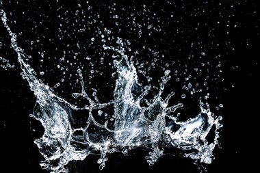Splashing water on a black background. water splash refreshing black background