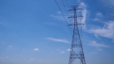 High voltage transmission towers with complex steel structures.