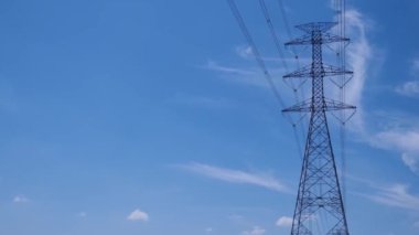 High voltage transmission towers with complex steel structures.